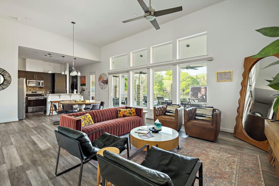 This living room is equal parts cozy and chic, featuring stylish seating, soaring ceilings, and tons of natural light—perfect for lounging or entertaining.