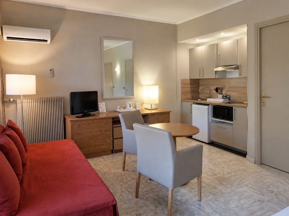 Comfort Room, Kitchenette | Living area | Flat-screen TV