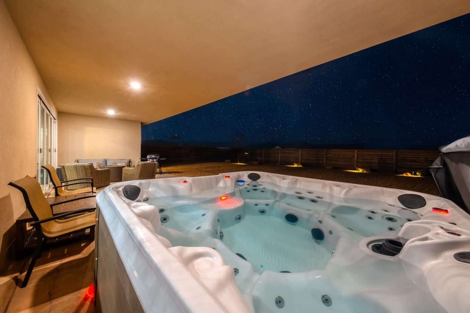 The back patio is the an incredible place to take in the dark starry skies of southern Utah. The large glass doors open fully, making the indoors and outdoors blend seamlessly. Tell stories 'round the fire pit or soak in the private hot tub!