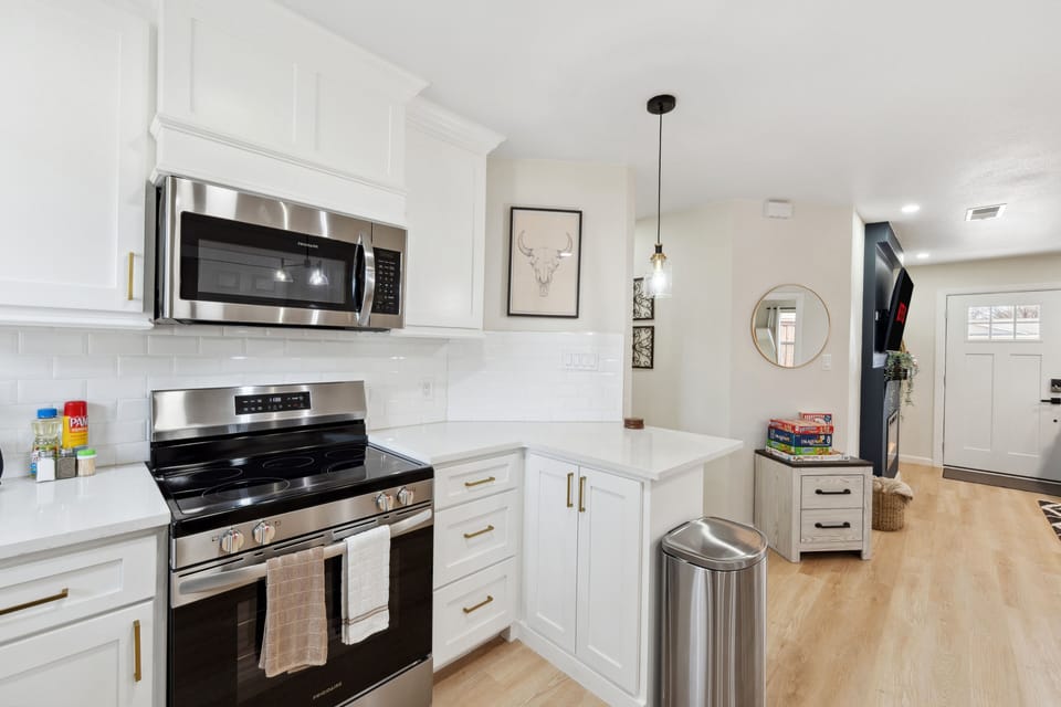 Cook and entertain with ease in this modern kitchen, featuring sleek appliances and plenty of counter space.