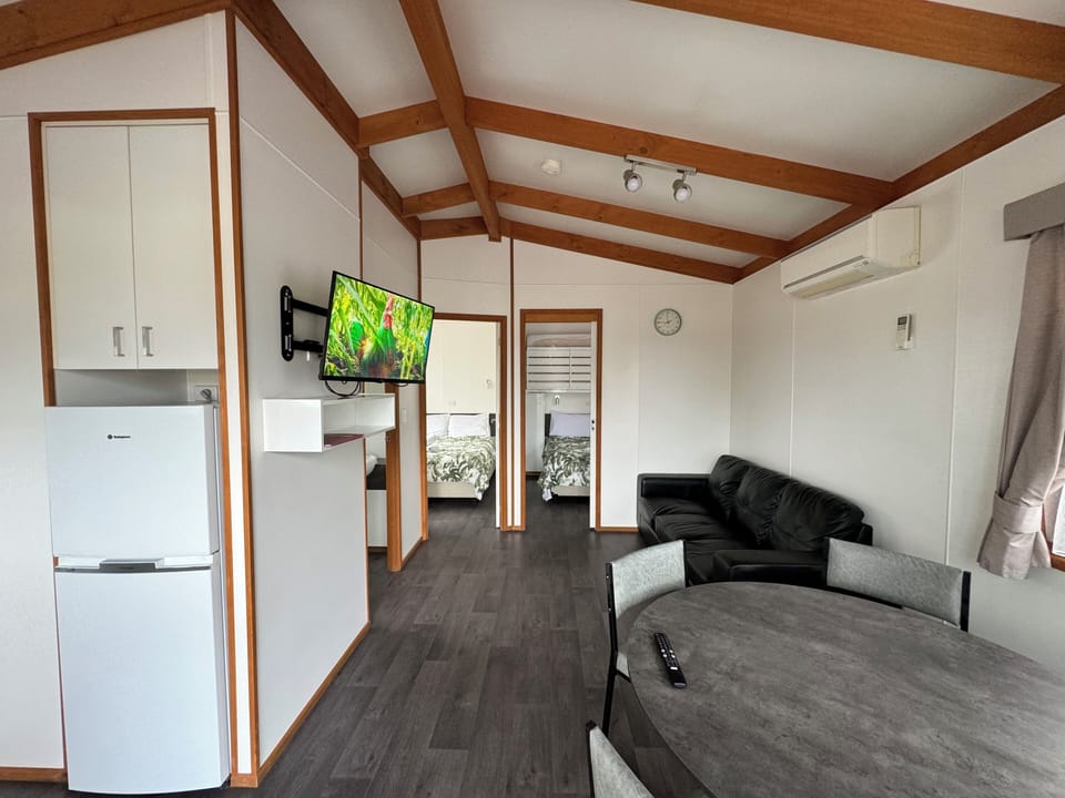 Deluxe Cabin | Living area | Flat-screen TV