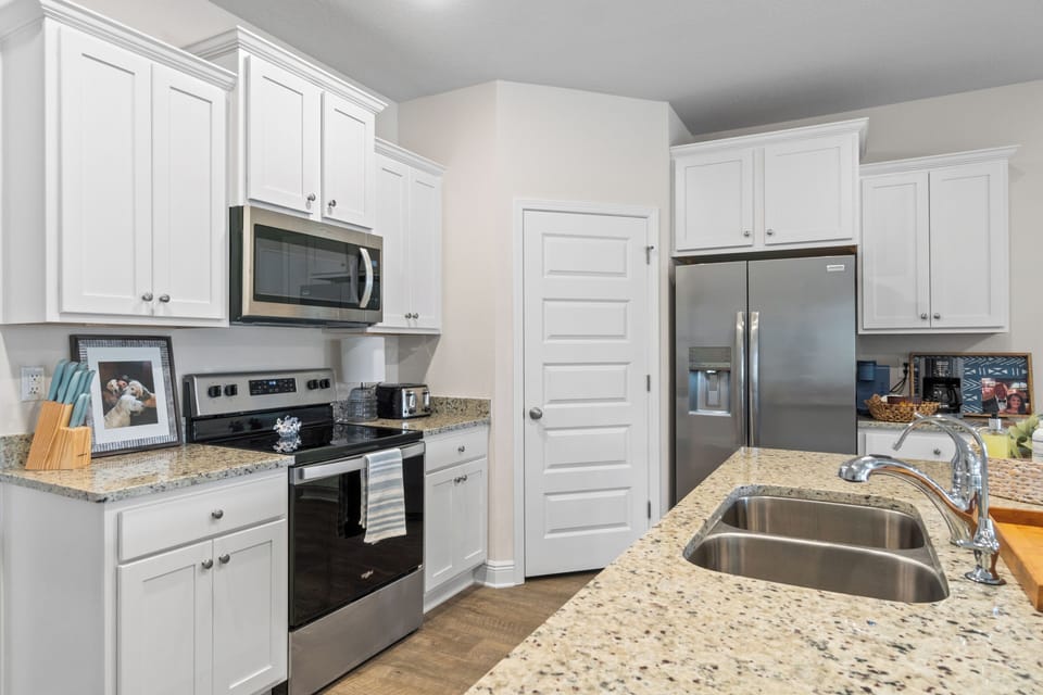 Your fully equipped kitchen features granite countertops, stainless steel appliances, and ample cabinet space for preparing memorable meals during your stay.