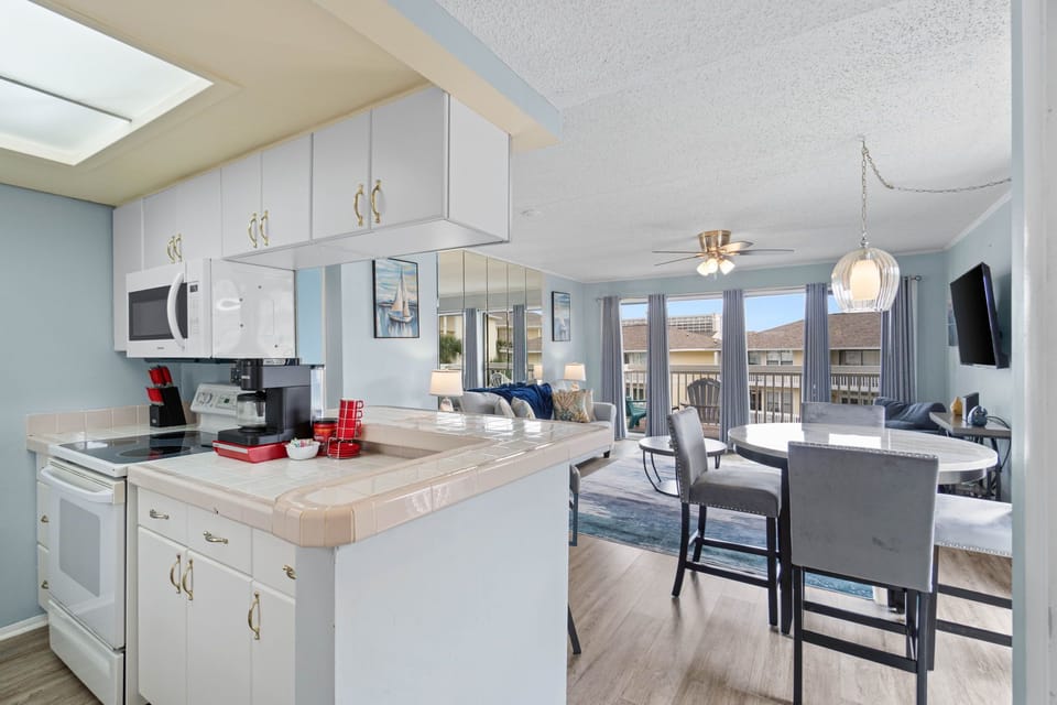 A kitchen with a view! Enjoy a fully equipped space that looks out over the living area and through to the balcony views.