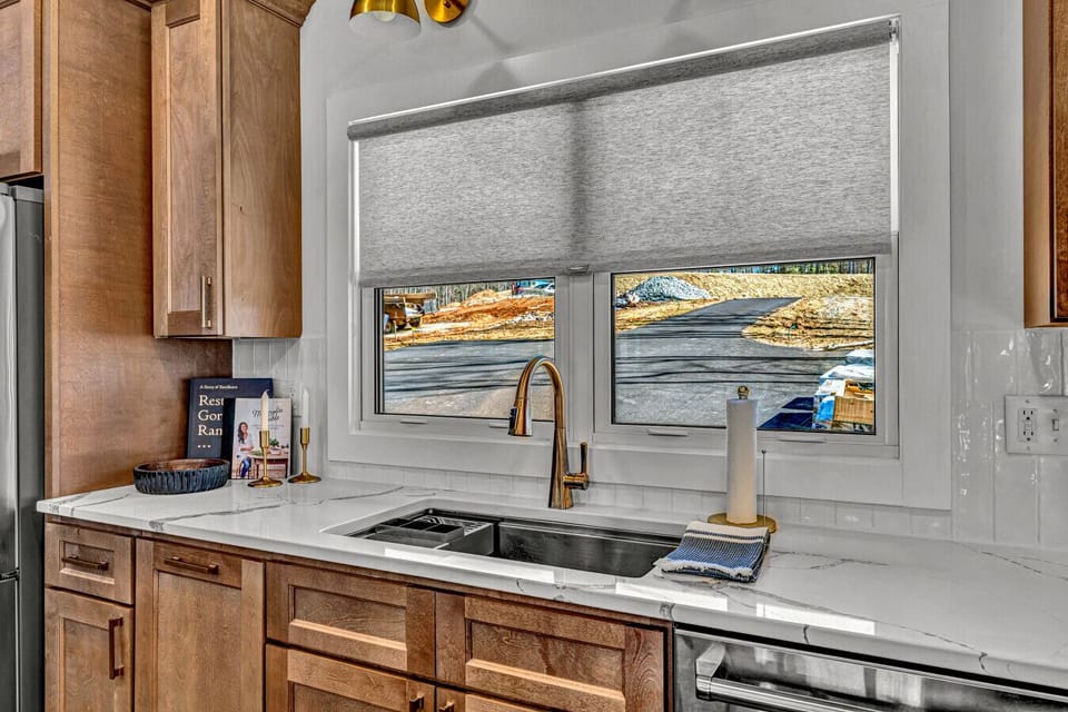 Large sink and pull down shades for additional privacy.