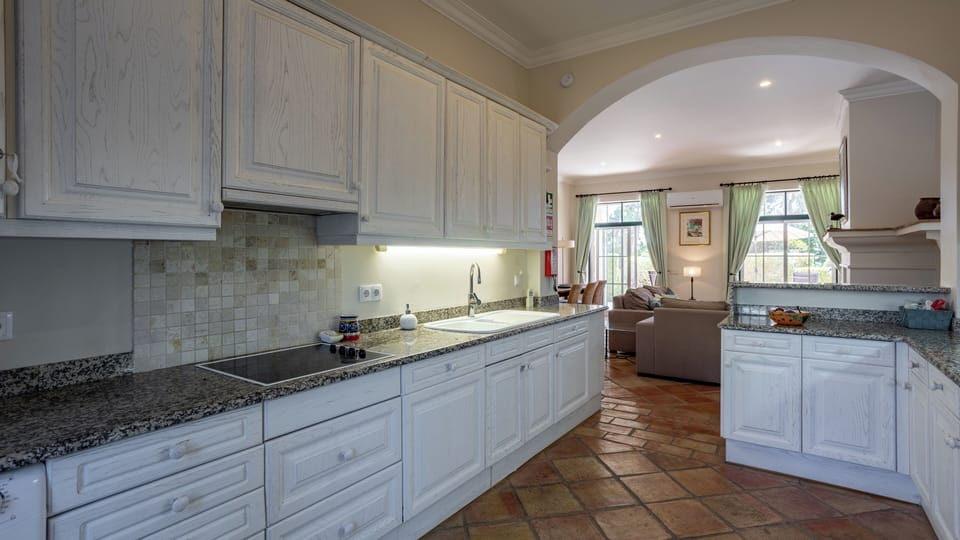 Well equipped kitchen with living room beyond