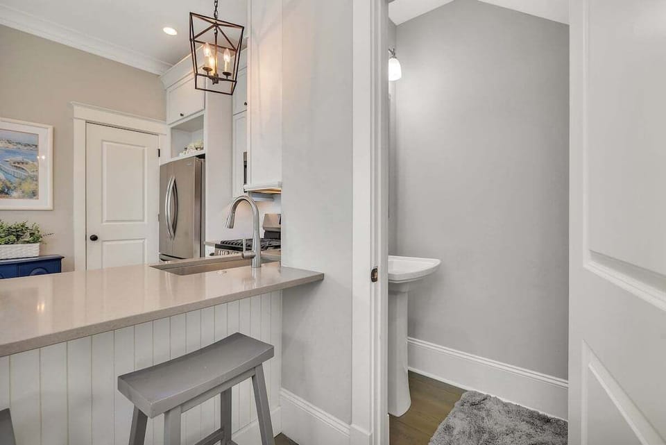 Kitchen island with bar stool and stainless steel refrigerator