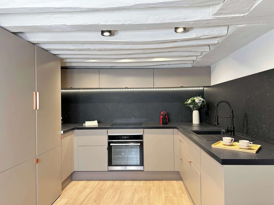 Spacious kitchen with a modern touch, offering a perfect space for both cooking and socializing