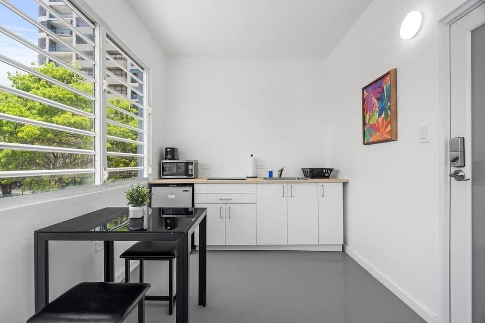 Enter the light-filled kitchenette, fully equipped with modern amenities, creating an ideal space for your stay.