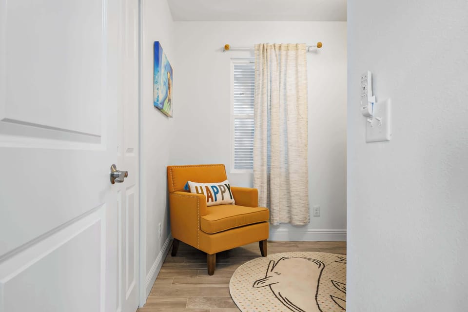Cozy reading nook with a mustard armchair and cheerful decor.