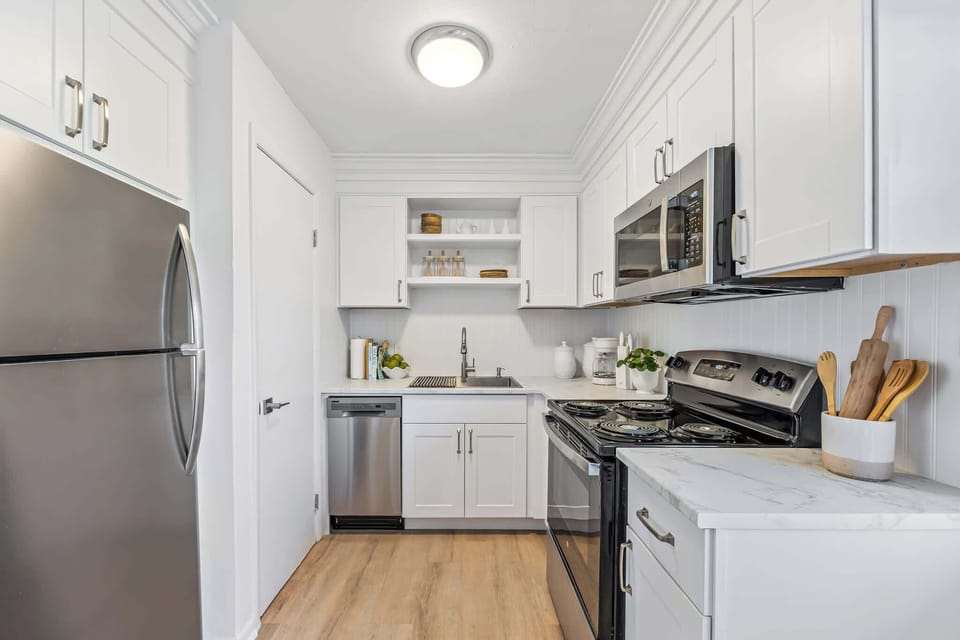Modern kitchen with stainless steel appliances and white cabinetry