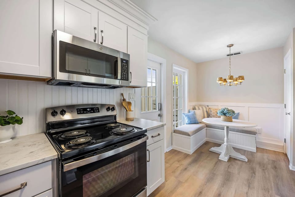 Modern kitchen with stainless steel appliances and a cozy breakfast nook.