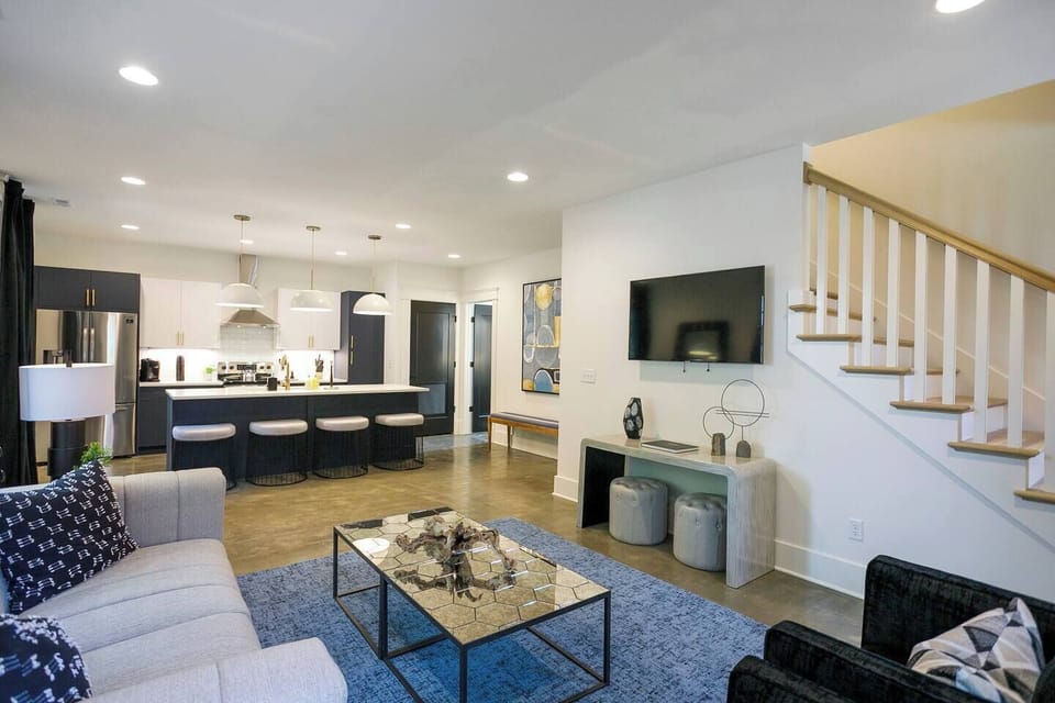 Open floor plan with kitchen, living room, and half bath on the entry level floor.