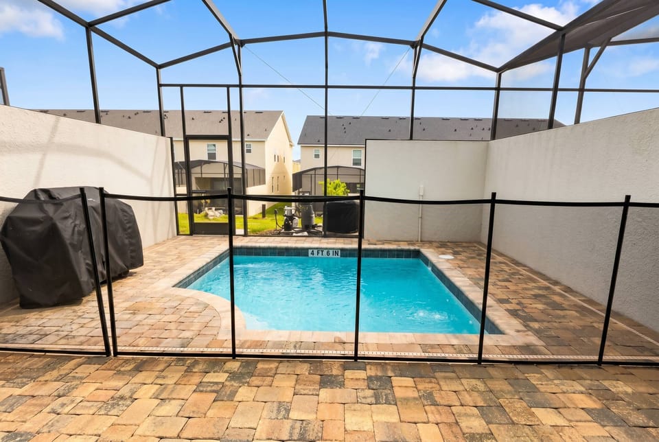 Step outside to your private oasis with a sparkling pool and a stunning stone patio. The screened enclosure lets you enjoy a refreshing swim while taking in the lush views and peaceful atmosphere of your vacation home.