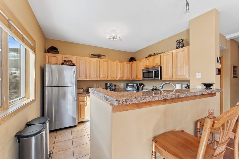 Step into your fully-equipped kitchen with granite countertops, stainless appliances, and natural light. You'll love preparing meals with ample counter space and modern conveniences at your fingertips.