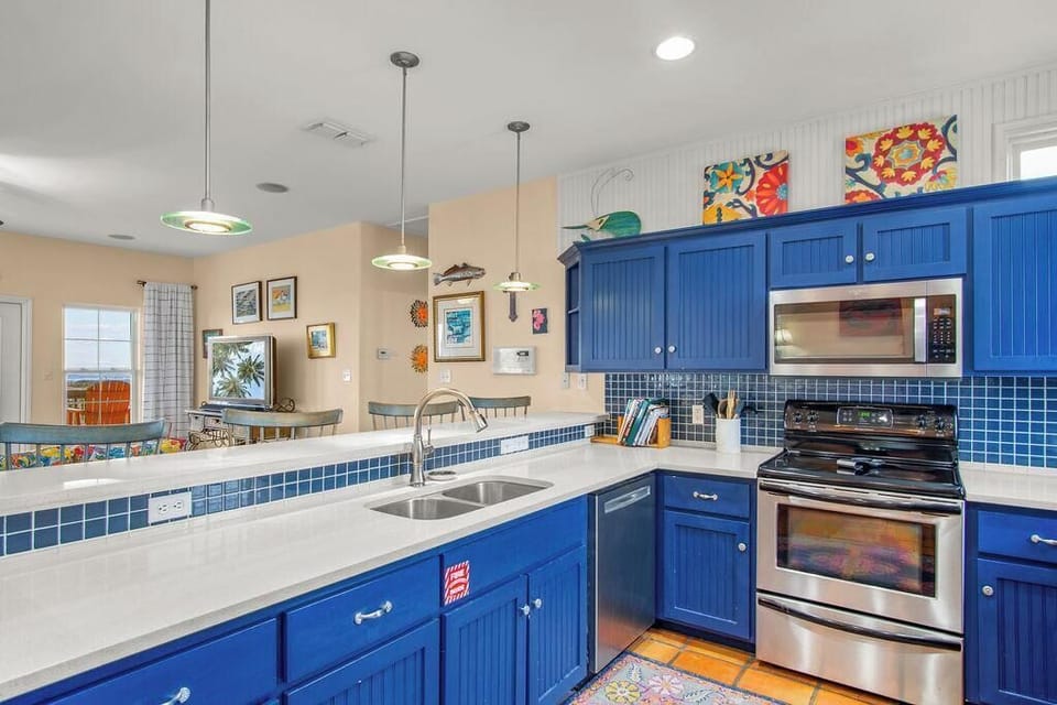Features a large island, ample cabinetry, and high-end appliances, making it perfect for cooking, entertaining, and gathering with loved ones. 