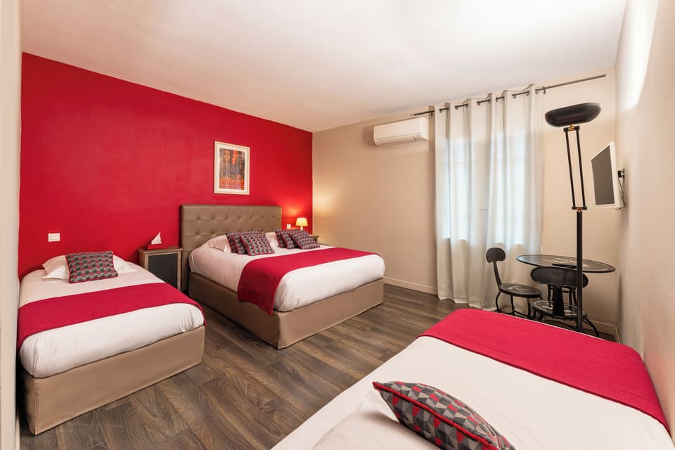 Family Room | Minibar, in-room safe, individually decorated, desk