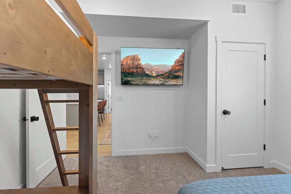 Bedroom 2 with twin/queen bunk bed, twin/twin bunk bed, and Smart TV