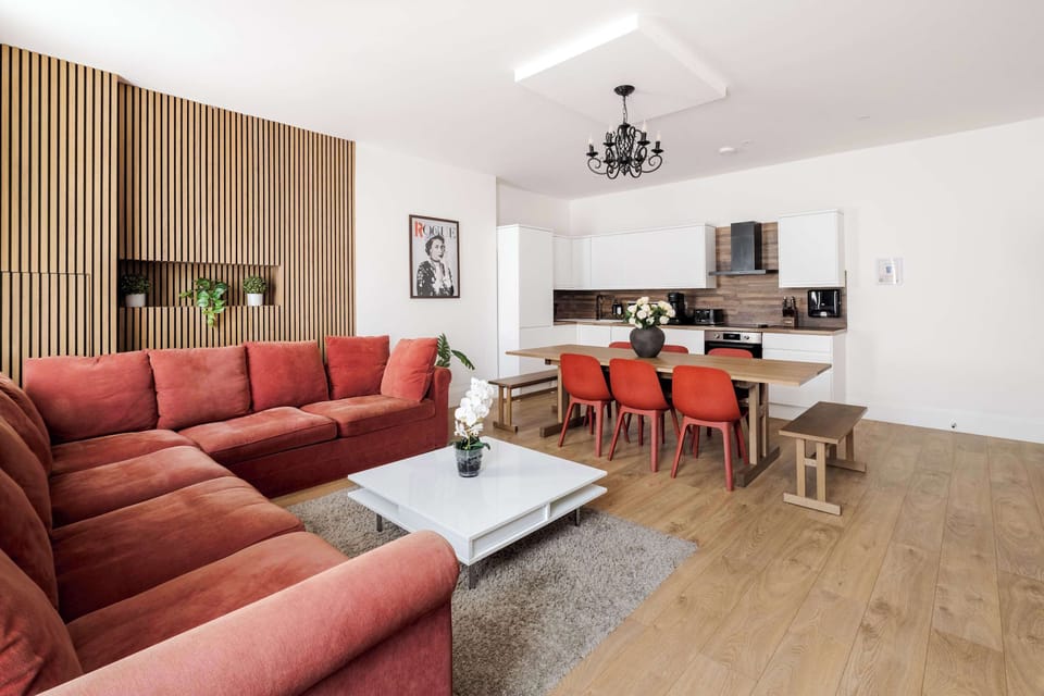 Living Room | The beautiful living room features a 75 inch TV, full air conditioning, and a large sofa that converts into a sofa bed, creating a bright space ideal for relaxing, unwinding after a day in the city, or enjoying quality time with family 