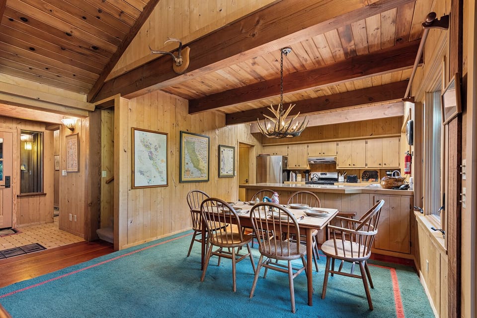 Classic River styling - wine county maps, an antler chandelier, exposed beam ceilings.