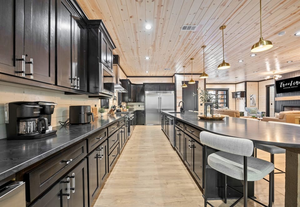With its long countertops, abundant storage, and top-of-the-line appliances, this well-equipped kitchen makes cooking a breeze for any size gathering.