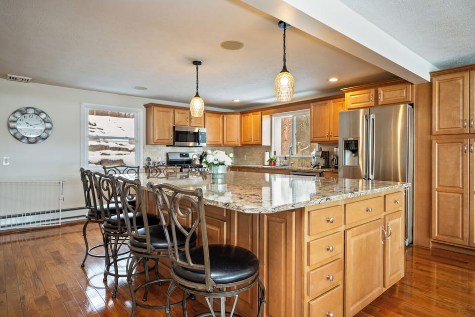 A main open-concept kitchen with a 12 ft island that beckons culinary creativity