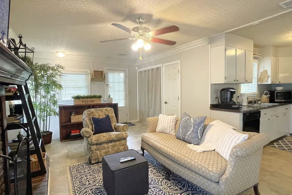 Family room features a cozy fireplace with natural gas logs and laundry closet