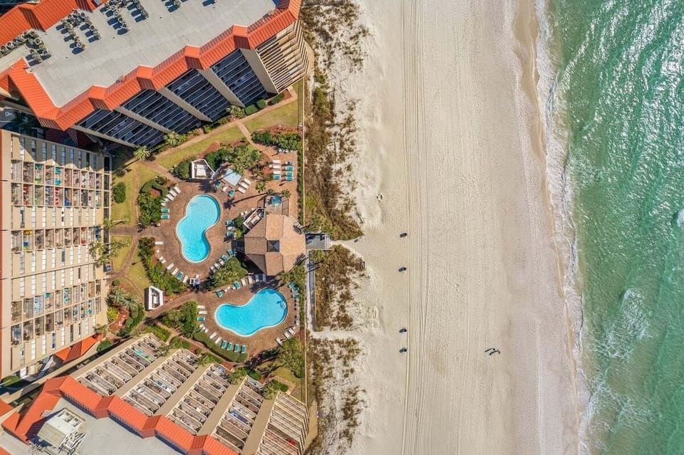 The beachside community pool area features two sparkling pools, a relaxing hot tub, a kiddie pool, and plenty of lounge chairs. Enjoy shaded areas and breathtaking ocean views for the perfect day by the water.