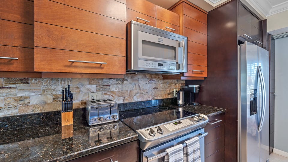 Enjoy the high-end finishes and open layout of the kitchen, allowing you to stay connected with your family and guests while prepping meals in your beautiful Sarasota vacation home.