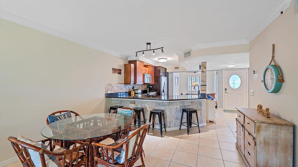 Gather for meals at the comfortable dining table, ideally situated between the spacious living area and the beautifully updated kitchen, perfect for your Sarasota family dinners.