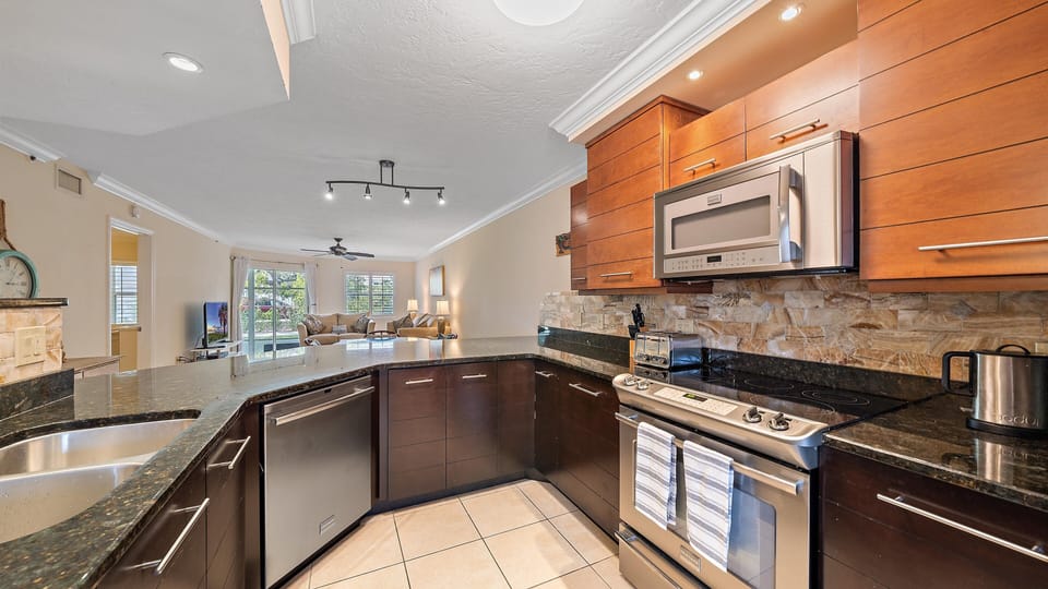 The gourmet kitchen is equipped with modern stainless steel appliances and plenty of counter space, making cooking a breeze before you head out to the nearby Siesta Key beaches or community pool.