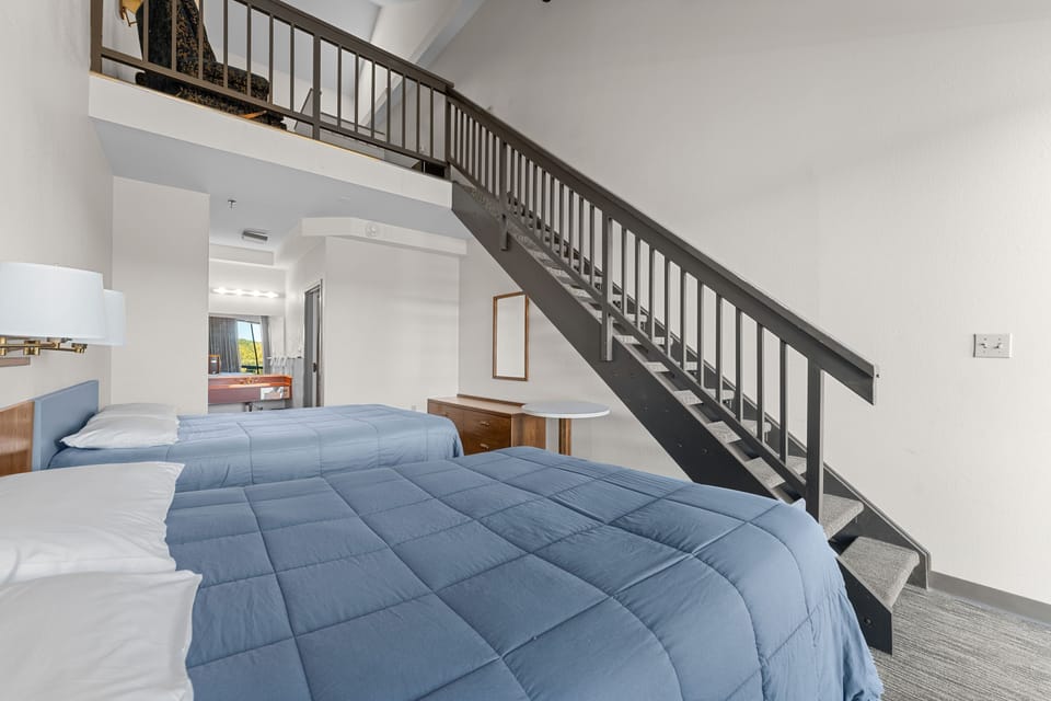 Cozy and spacious loft-style room with plush queen beds, offering comfort and relaxation after a day of adventure.