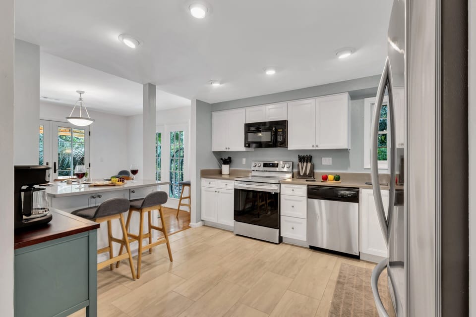Fully stocked kitchen with modern stainless appliances and ample prep space.