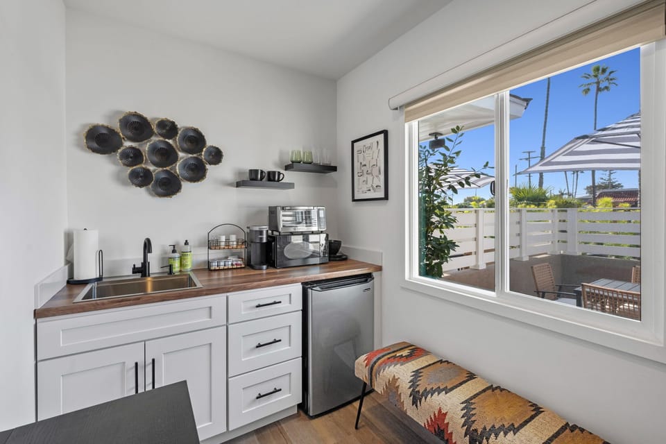 This modern, well equipped kitchenette with a small fridge, microwave, toaster oven/air fryer combo, and Keurig coffee maker -perfect for effortless meals and morning coffee.