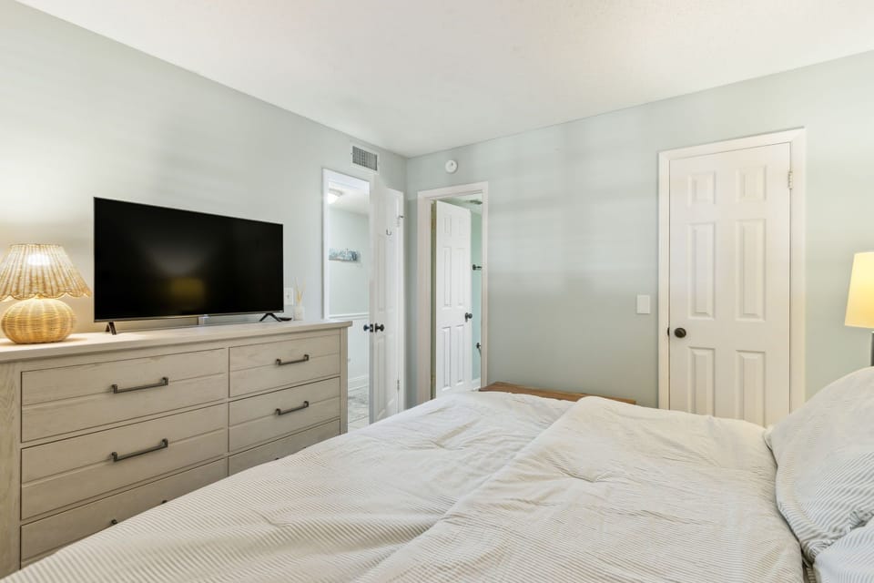 Guest Bedroom has Dresser, TV and Access to Shared Hallway Bathroom