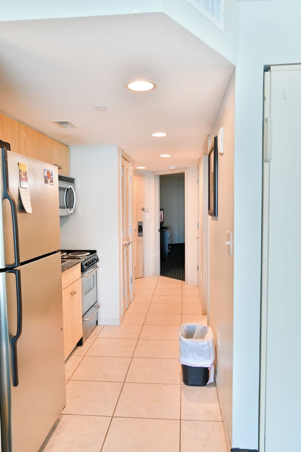 Fully stocked kitchen with coffee maker, sink, and dishwasher.