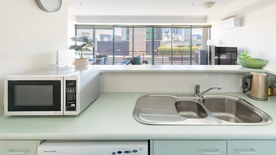 Cook with ease in a functional u-shaped kitchen offering an integrated microwave nook and wide double-sink basin.