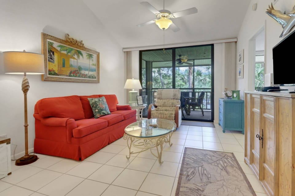 Sliding glass doors in the main living area open to the screened balcony.
