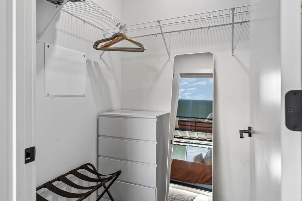 King over King bunk bed in Bedroom #2 with room-darkening shades, full length mirror and a large dresser + closet for storing personal items.