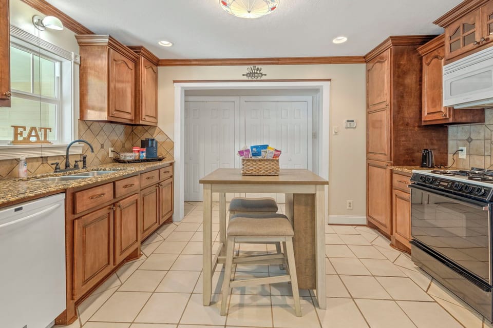 Spacious Gallery Kitchen with a Mini-Island
