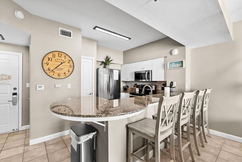 Bright and inviting entrance with a peek at the fully equipped kitchen and living space.