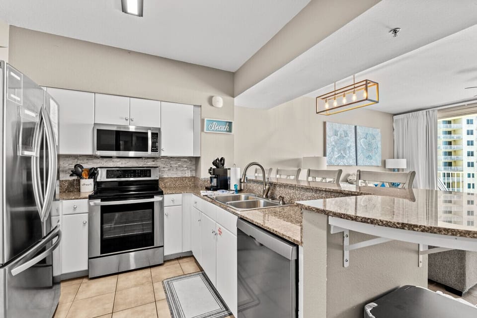 Fully stocked kitchen featuring stainless steel appliances, a Keurig, and plenty of counter space.