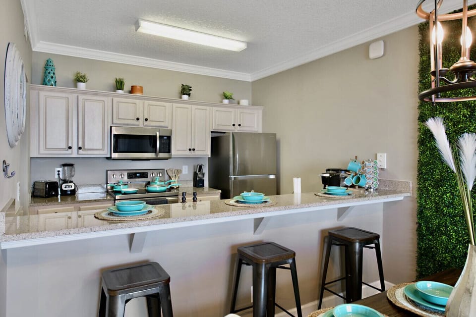 Cook and dine in style with this fully equipped modern kitchen, featuring sleek appliances, granite countertops, and a cozy breakfast bar for a perfect start to your day