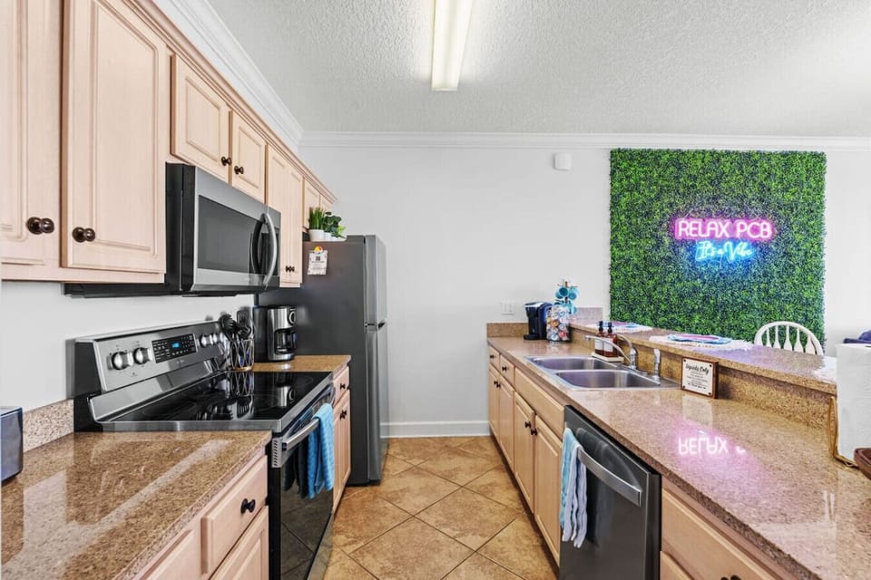 This stylish kitchen boasts stainless steel appliances, ample counter space, and a convenient coffee station, perfect for starting your day.