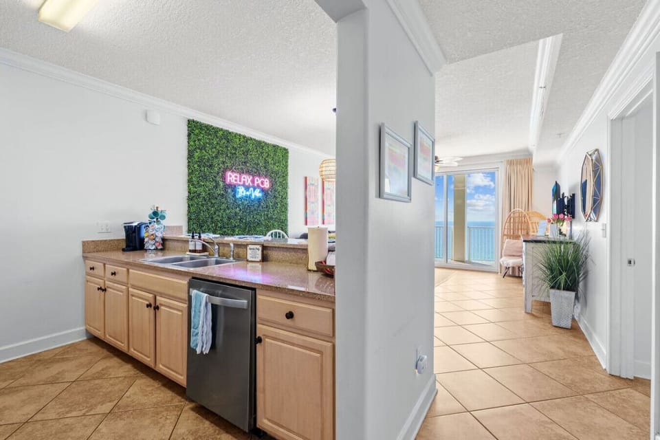 Enjoy cooking with a view in this fully equipped kitchen, seamlessly connected to the dining and living area, featuring a stunning ocean backdrop