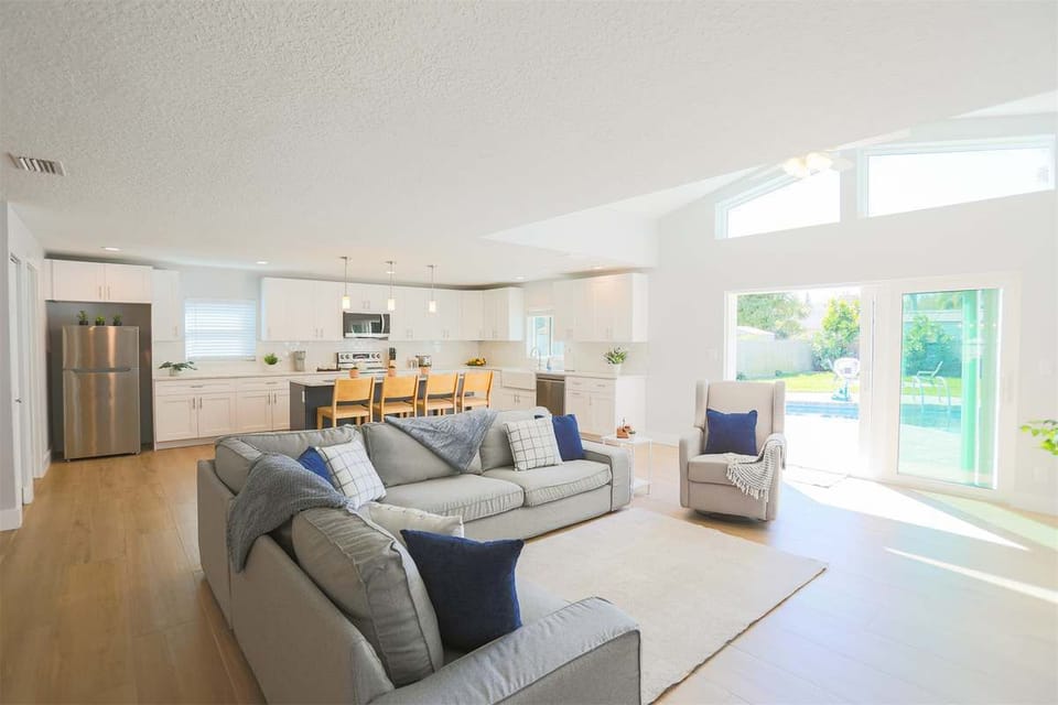 Sunlit living space with comfortable seating and modern touches, perfect for unwinding.