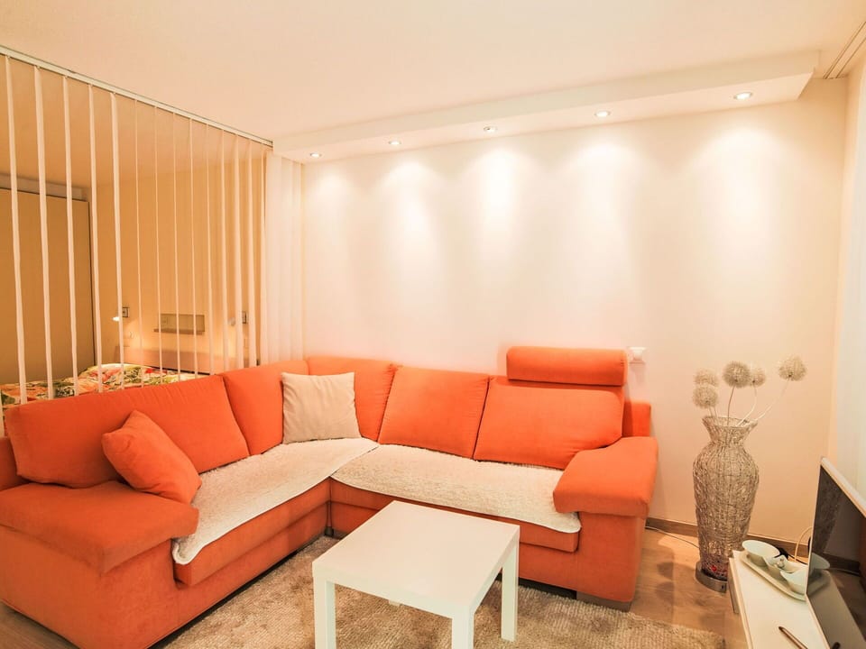Furniture, Interior Design, Couch, Flooring, Wood, Floor, Orange, Living Room, Lighting, Apartment