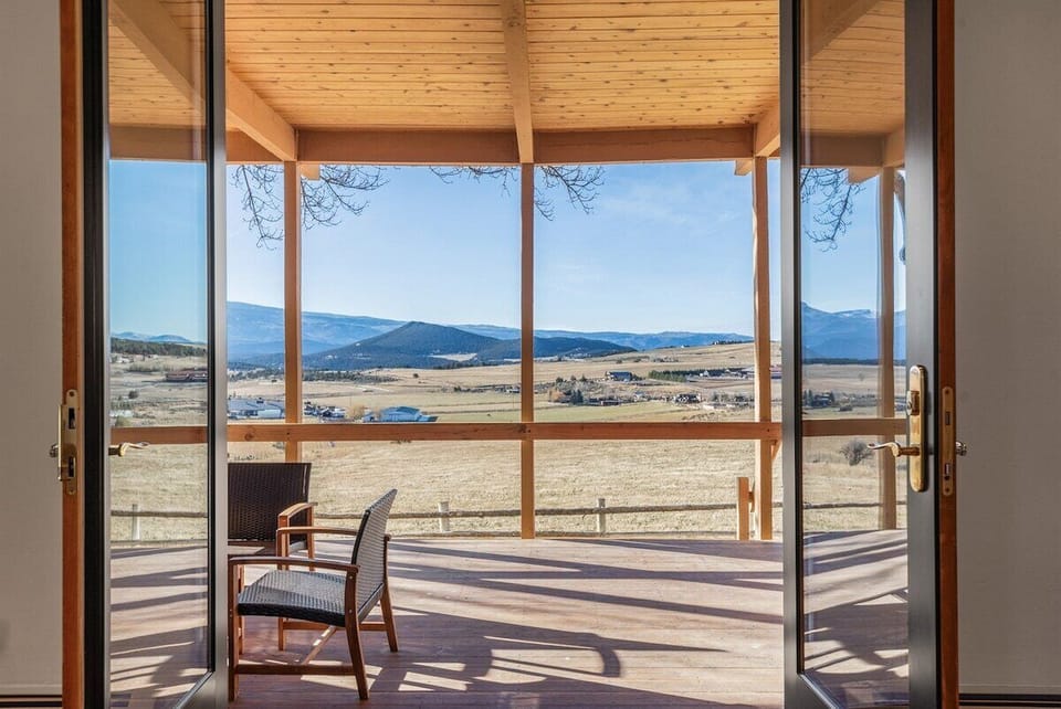 Large double doors opening up to your expansive covered porch with views of the entire valley.