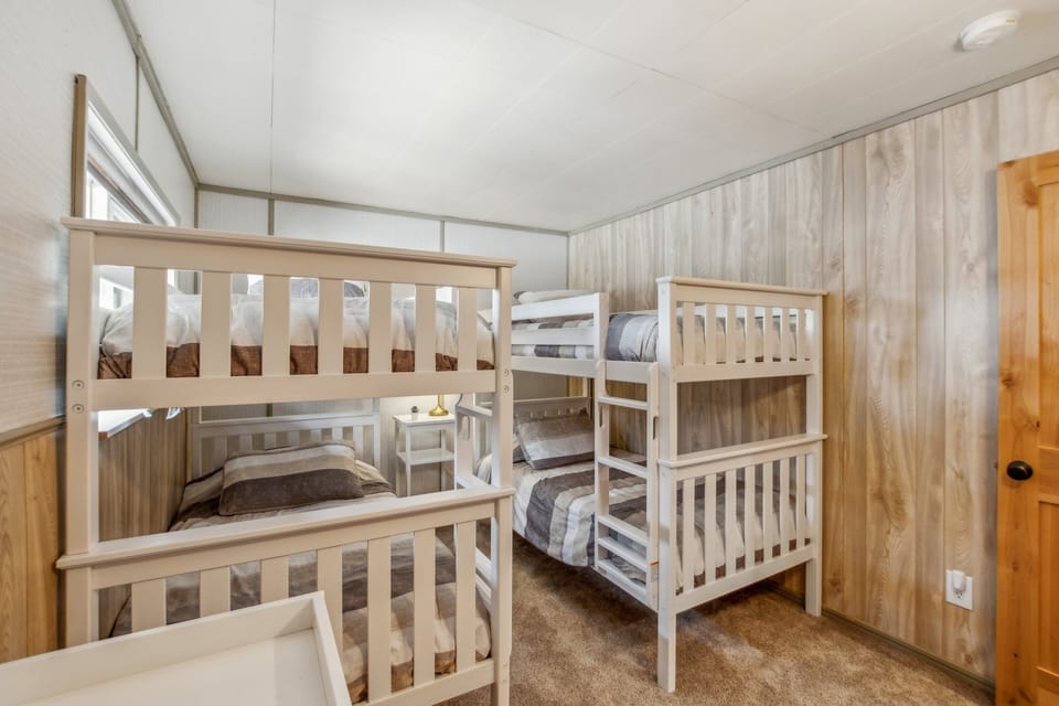 Third bedroom with comfy bunks and reading lights for all