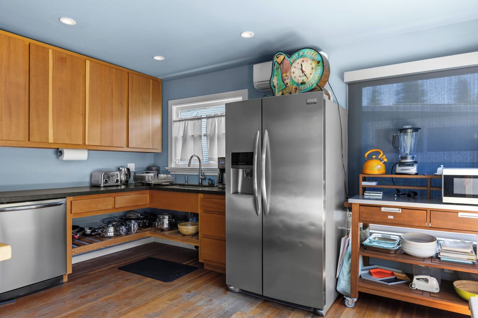 Sleek updates modernize this riverfront cabin kitchen with stainless steel appliances and counter space for cooking.