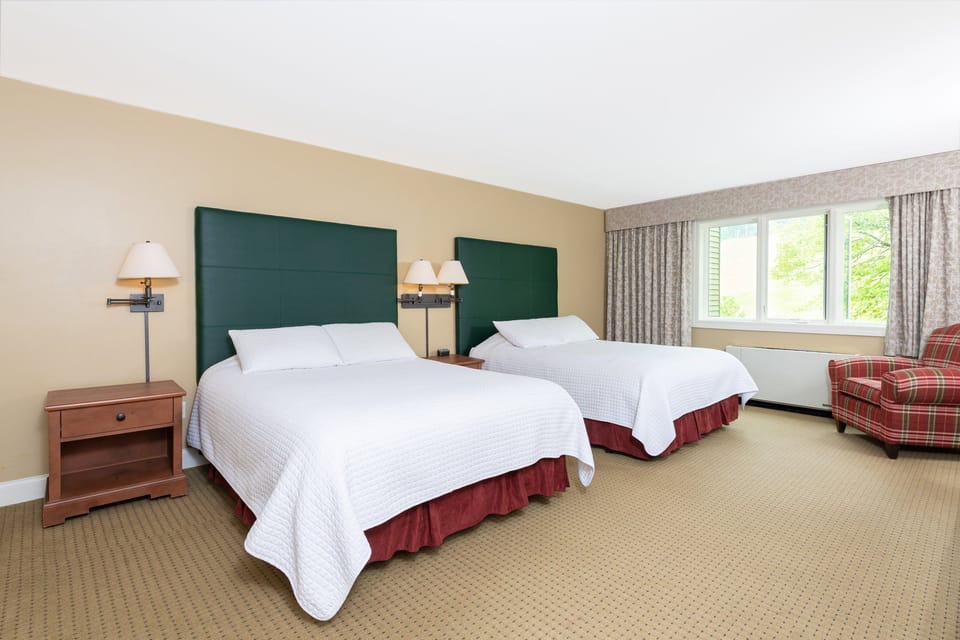 Spacious bedroom with a serene ambiance and natural light, offering a tranquil retreat for rest and relaxation.